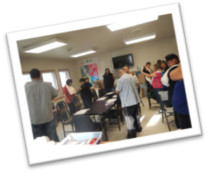 People walking around and interacting in classroom